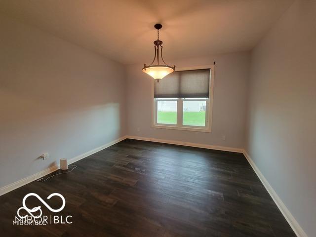 unfurnished room featuring dark hardwood / wood-style flooring