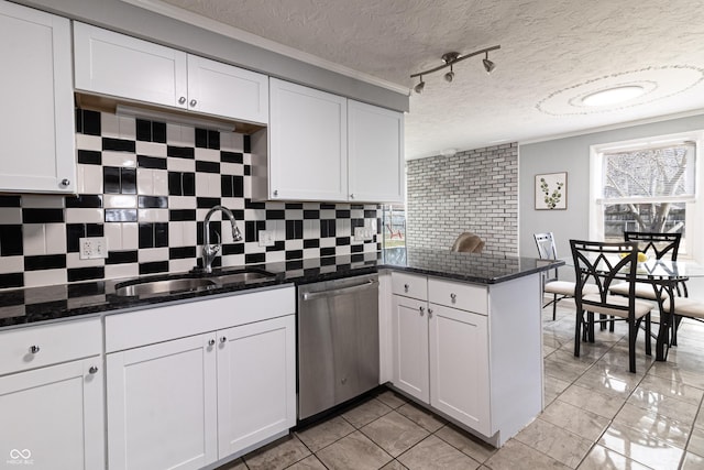 kitchen with white cabinets, dishwasher, a peninsula, and a sink