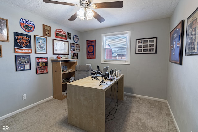 office area with ceiling fan, a textured ceiling, baseboards, and carpet floors