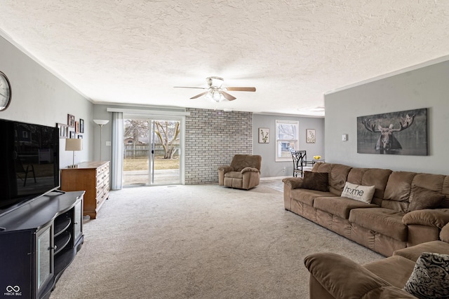 living area with a ceiling fan, carpet flooring, and a textured ceiling