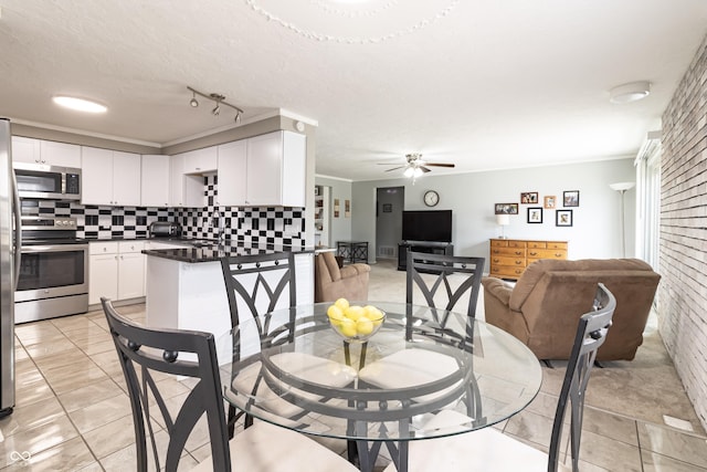 dining area with light tile patterned floors, ceiling fan, and ornamental molding