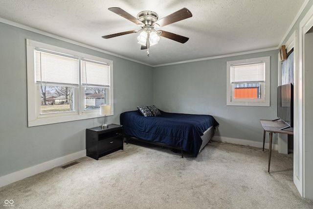 carpeted bedroom with crown molding, baseboards, visible vents, and a textured ceiling