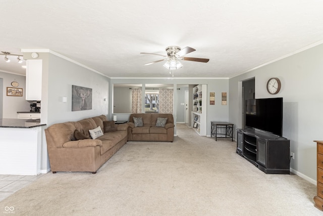 living area with a textured ceiling, crown molding, baseboards, light colored carpet, and ceiling fan