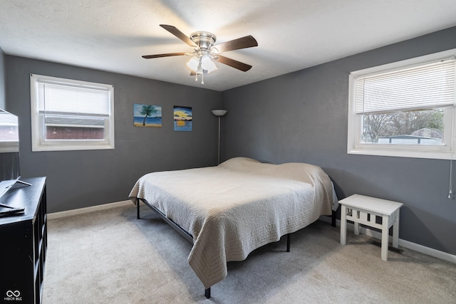 bedroom featuring multiple windows, carpet flooring, and baseboards