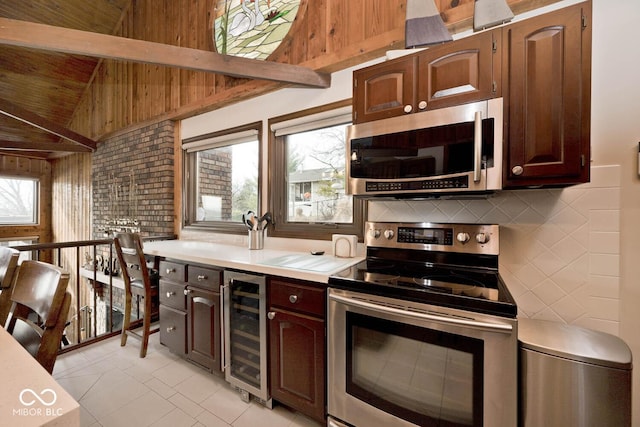 kitchen with appliances with stainless steel finishes, tasteful backsplash, vaulted ceiling with beams, wine cooler, and dark brown cabinets