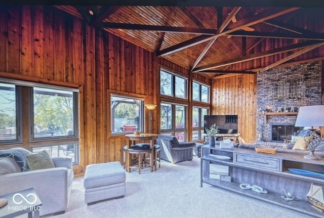 living room featuring a brick fireplace, wooden ceiling, wooden walls, beam ceiling, and carpet