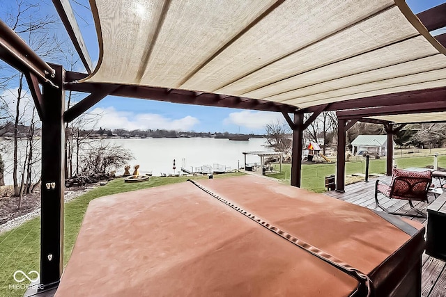 view of patio with a water view and a pergola