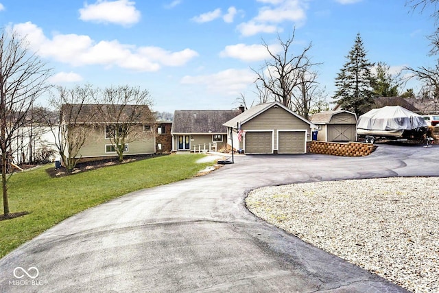 single story home with a shed, a garage, and a front lawn