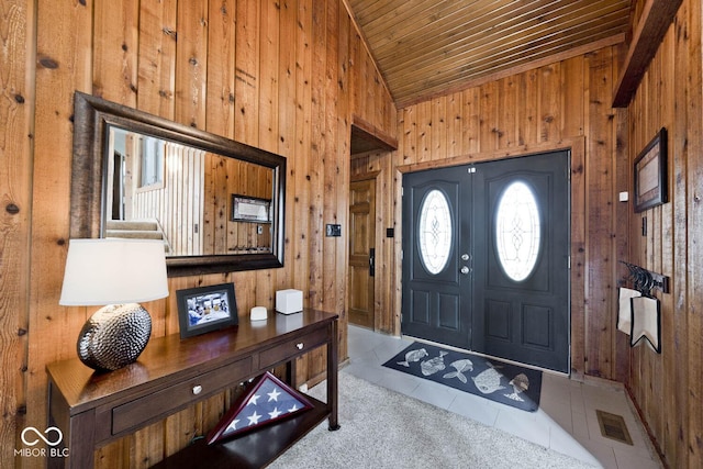 entrance foyer with lofted ceiling, tile patterned floors, wooden walls, and wood ceiling