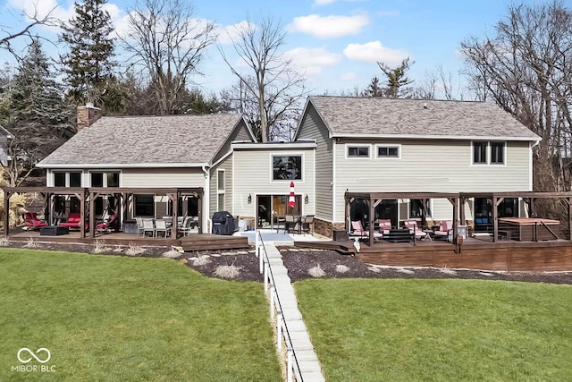 rear view of property with a wooden deck, a yard, and a patio area