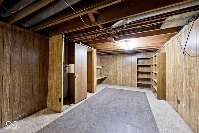 unfinished basement featuring wooden walls