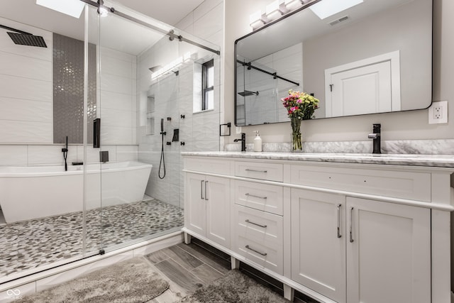 bathroom featuring vanity and plus walk in shower