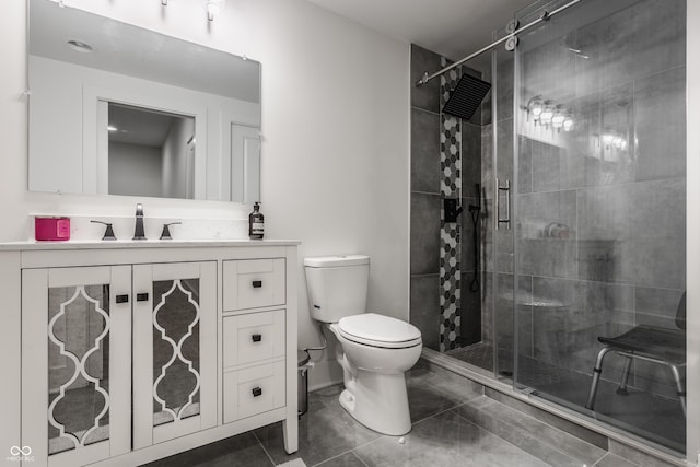 bathroom featuring vanity, an enclosed shower, and toilet