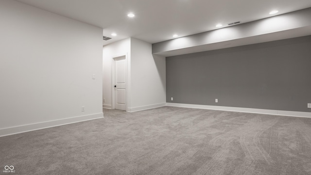 basement featuring light colored carpet