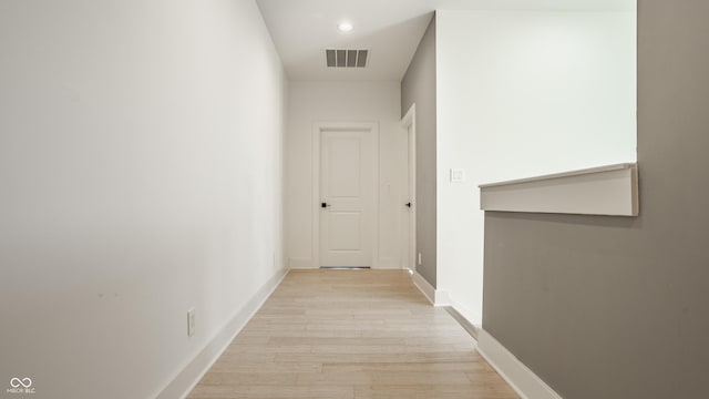 corridor with light hardwood / wood-style floors