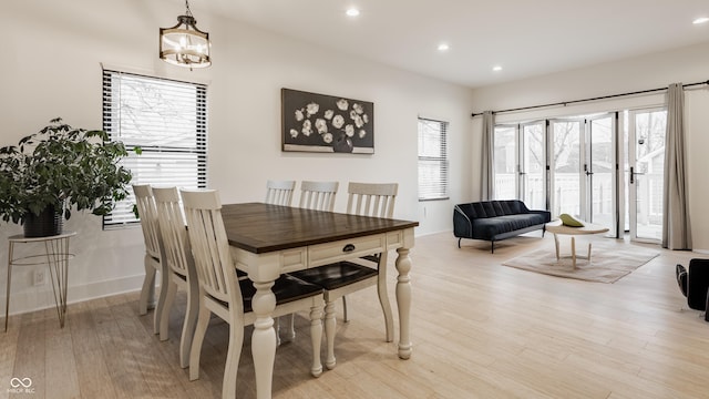 dining space featuring a notable chandelier and light hardwood / wood-style flooring