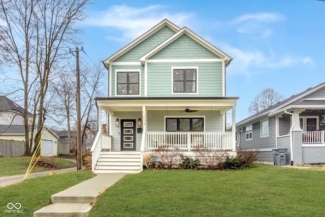 view of front of home with a porch, ceiling fan, and a front lawn