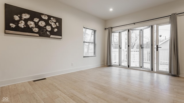 spare room featuring light hardwood / wood-style flooring