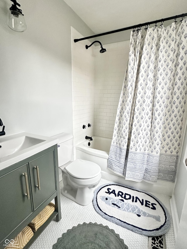 full bathroom with shower / tub combo, vanity, tile patterned floors, and toilet