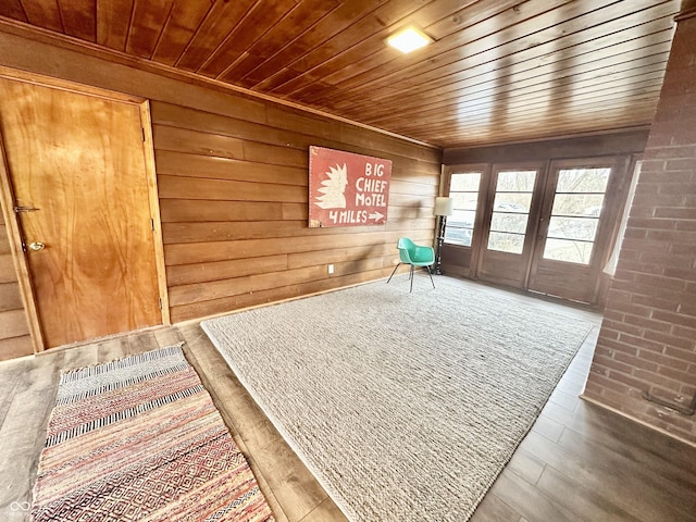 living area featuring wood ceiling, hardwood / wood-style floors, and wood walls