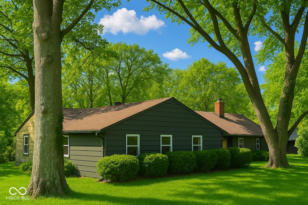 6220 Dean Rd, Indianapolis, IN 46220 - view of side of property featuring a yard, a chimney, and roof with shingles