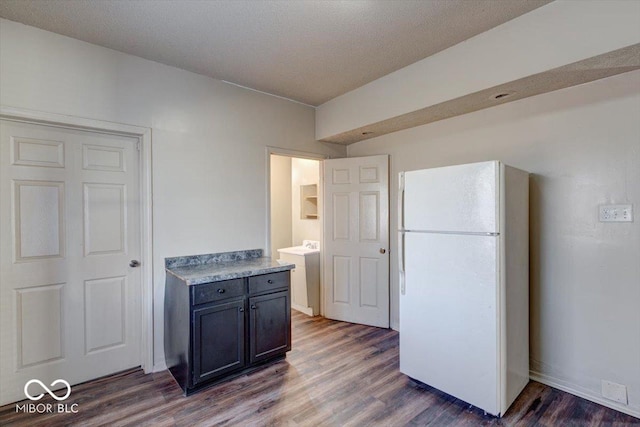 kitchen with dark hardwood / wood-style floors and white refrigerator