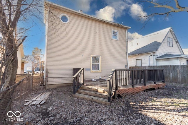 rear view of house featuring a wooden deck