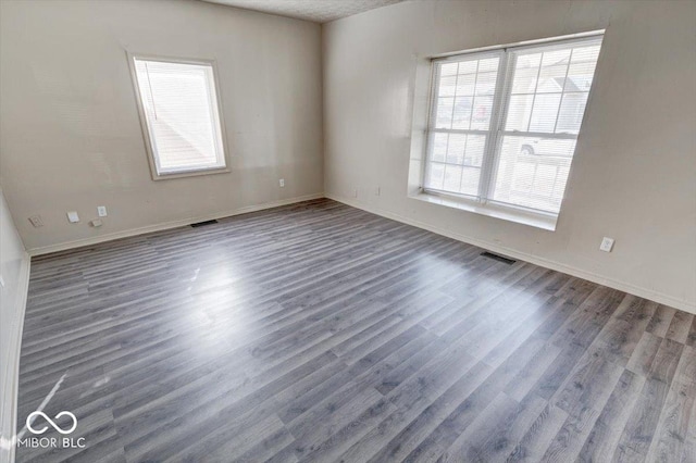 unfurnished room featuring dark hardwood / wood-style flooring