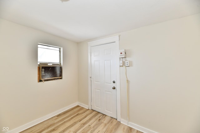 interior space featuring cooling unit and light hardwood / wood-style floors