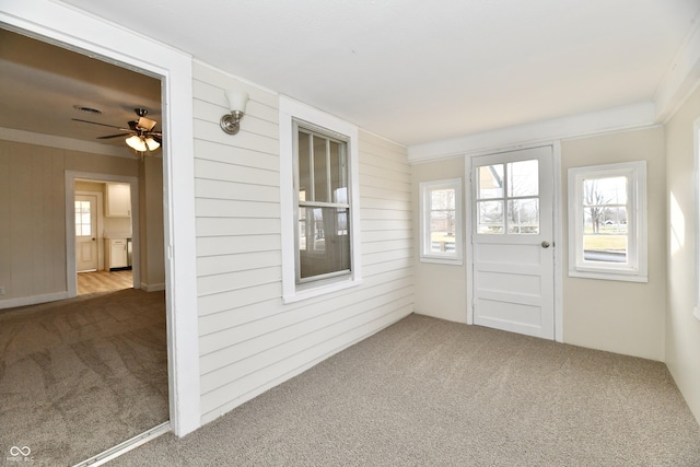 unfurnished sunroom with ceiling fan