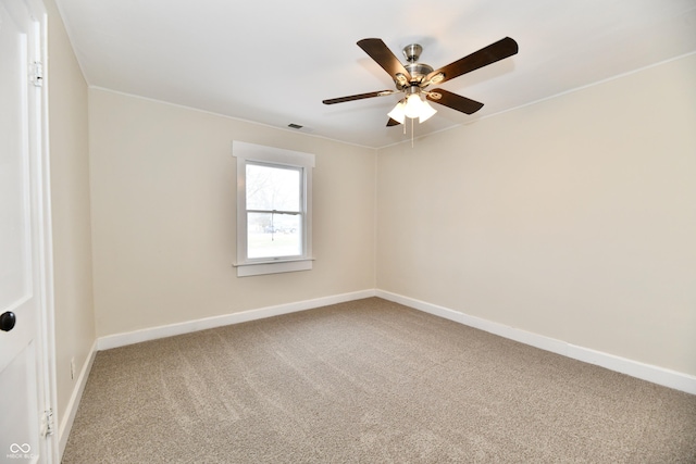 spare room featuring carpet and ceiling fan