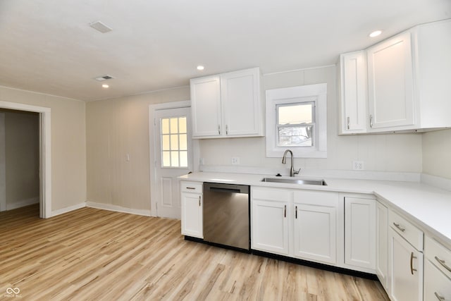 kitchen featuring white cabinetry, dishwasher, sink, and light hardwood / wood-style flooring