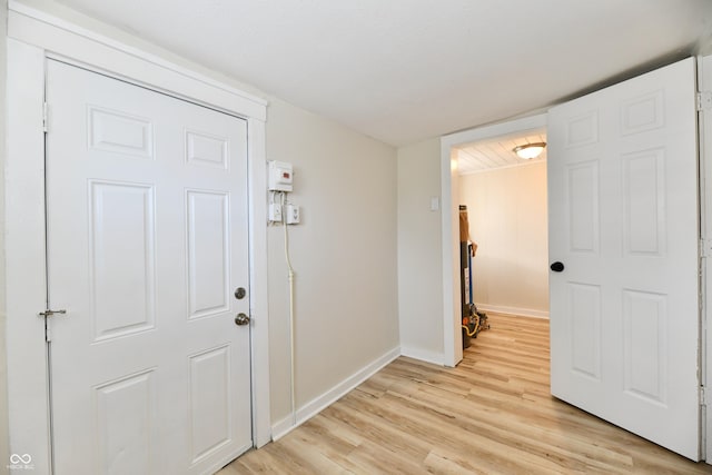 hallway with light hardwood / wood-style flooring