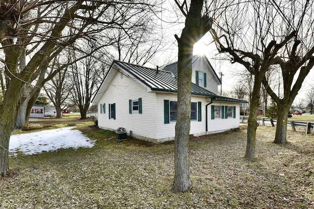 view of snowy exterior featuring central AC unit