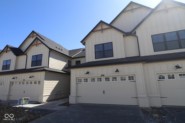 view of front facade with an attached garage, board and batten siding, and driveway