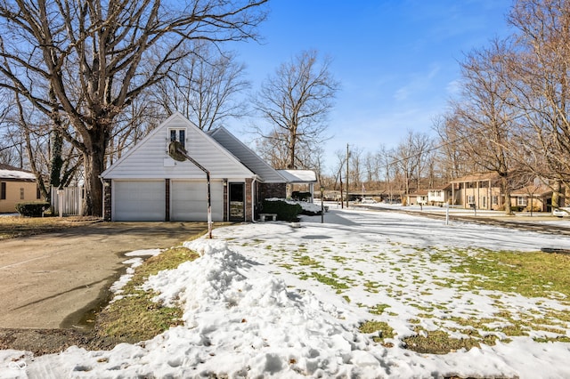 view of snow covered exterior with a garage