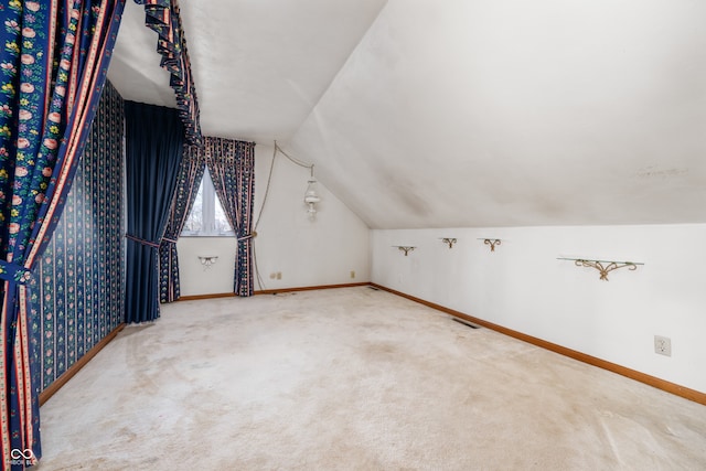 additional living space featuring lofted ceiling and carpet floors