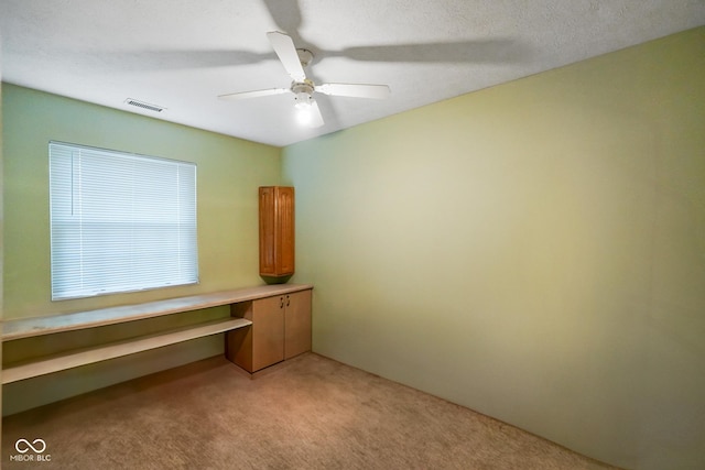 unfurnished office with light carpet and ceiling fan