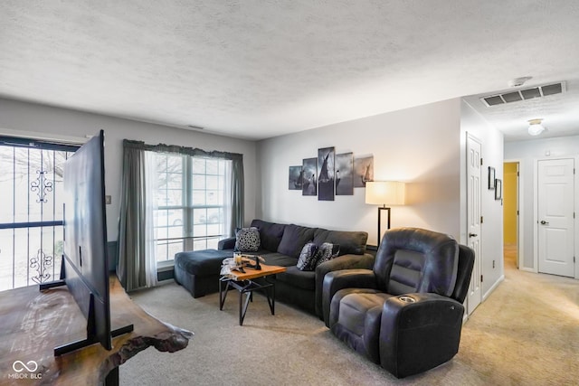 living room with light colored carpet and a textured ceiling