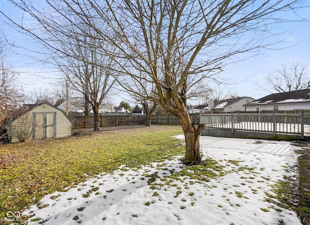 snowy yard with a shed