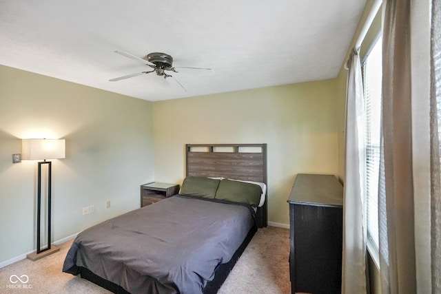 bedroom featuring light colored carpet and ceiling fan