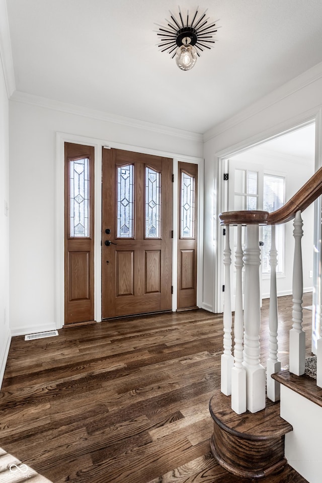 foyer entrance with ornamental molding, plenty of natural light, and dark hardwood / wood-style flooring