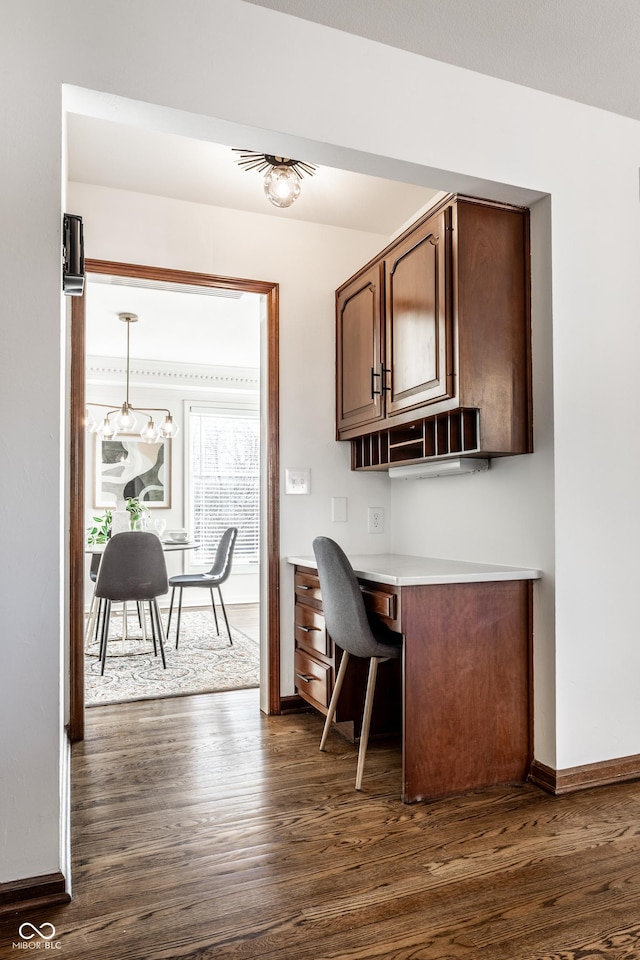 interior space featuring built in desk and dark hardwood / wood-style floors