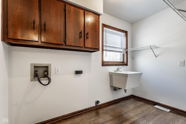 laundry room with sink, hookup for a washing machine, dark wood-type flooring, and cabinets