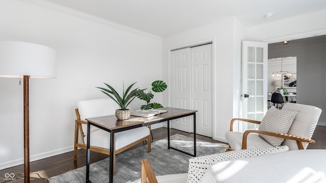 office space with dark wood-type flooring, crown molding, and a notable chandelier