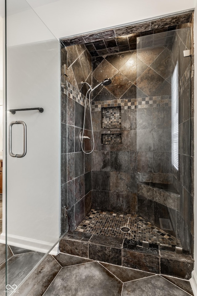 bathroom featuring a shower with shower door