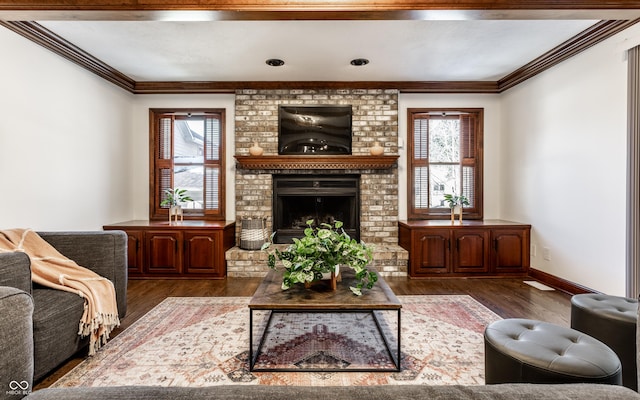 living room with ornamental molding, a brick fireplace, and dark hardwood / wood-style flooring