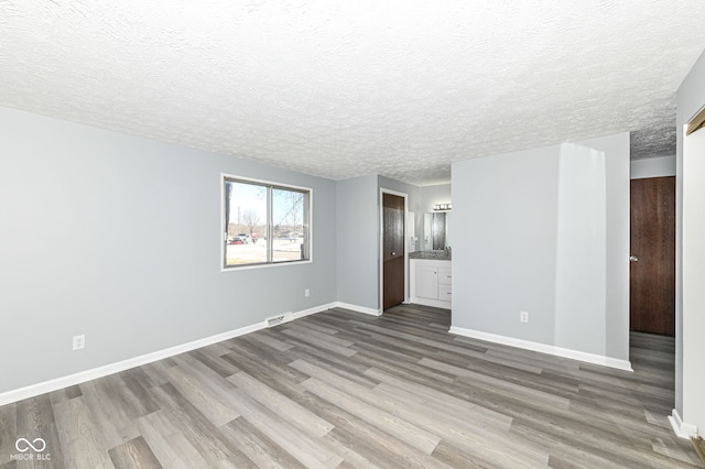 empty room featuring hardwood / wood-style floors and a textured ceiling