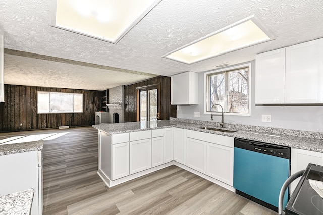 kitchen featuring range with electric stovetop, white cabinetry, sink, and stainless steel dishwasher