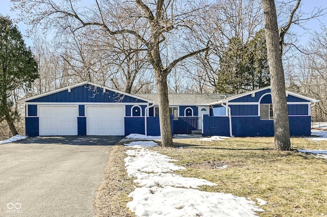 ranch-style home featuring a garage